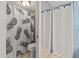 Clean bathroom with a pineapple-themed shower curtain and updated toilet at 2824 Countryside Blvd # 326, Clearwater, FL 33761