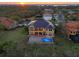 Luxury home, pool, and spa viewed from above at sunset at 288 Mobbly Bay Dr, Oldsmar, FL 34677