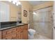 Clean bathroom with walk-in shower and wood cabinets at 288 Mobbly Bay Dr, Oldsmar, FL 34677