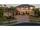 Two-story home with a three-car garage and elegant architectural details at 288 Mobbly Bay Dr, Oldsmar, FL 34677