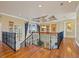 Upper hallway with hardwood floors and wrought iron railings at 288 Mobbly Bay Dr, Oldsmar, FL 34677