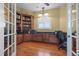 Spacious home office features built-in cabinetry and hardwood floors at 288 Mobbly Bay Dr, Oldsmar, FL 34677