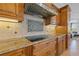 Kitchen with cooktop and granite countertops at 288 Mobbly Bay Dr, Oldsmar, FL 34677