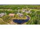 Aerial view of home backing onto pond showcasing landscaping and natural surroundings at 2987 Wentworth Way, Tarpon Springs, FL 34688