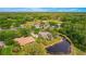 Aerial view of house and surrounding community featuring a golf course, ponds, and nature at 2987 Wentworth Way, Tarpon Springs, FL 34688