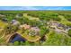 Aerial view of community with golf course, lakes and ponds amid lush green surroundings at 2987 Wentworth Way, Tarpon Springs, FL 34688