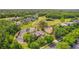 Aerial view of home in community with golf course and ponds in a lush, green setting at 2987 Wentworth Way, Tarpon Springs, FL 34688