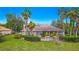 View of backyard featuring pool, patio, landscaping, and screened enclosure on a lush lawn at 2987 Wentworth Way, Tarpon Springs, FL 34688