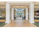 Bright and airy ballroom space with large windows, elegant columns, and chandelier lighting at 2987 Wentworth Way, Tarpon Springs, FL 34688