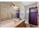 Bathroom featuring a single vanity, framed mirror and shower-tub combo at 2987 Wentworth Way, Tarpon Springs, FL 34688