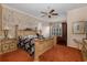 Cozy bedroom with a decorative wallpaper, ceiling fan, and warm-toned carpet at 2987 Wentworth Way, Tarpon Springs, FL 34688