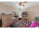 Bedroom features bright natural light, a ceiling fan, and vintage vanity at 2987 Wentworth Way, Tarpon Springs, FL 34688