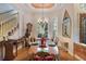 Formal dining room with a decorative chandelier and large windows at 2987 Wentworth Way, Tarpon Springs, FL 34688