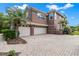 Large two story home with a three-car garage and paved driveway at 2987 Wentworth Way, Tarpon Springs, FL 34688