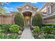 Inviting front entrance featuring a beautifully landscaped walkway and arched doorway at 2987 Wentworth Way, Tarpon Springs, FL 34688