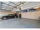 Well-lit garage with overhead storage provides ample space for parking and organization at 2987 Wentworth Way, Tarpon Springs, FL 34688