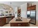 Kitchen island with stainless steel appliances and granite countertops at 2987 Wentworth Way, Tarpon Springs, FL 34688