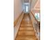 A long, wooden staircase featuring a white banister leading to the upper level at 2987 Wentworth Way, Tarpon Springs, FL 34688