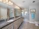 Spa-like bathroom with double sinks, granite countertops, and shower at 3010 Palm Key Ave, Oldsmar, FL 34677