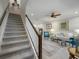 Open living room with gray carpet and teal armchairs at 3010 Palm Key Ave, Oldsmar, FL 34677