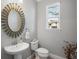 Elegant powder room with an ornate mirror and pedestal sink at 3010 Palm Key Ave, Oldsmar, FL 34677