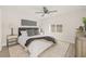 Main bedroom with ceiling fan, plush bed, and contemporary decor at 3034 Burlington N Ave, St Petersburg, FL 33713