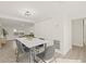 Dining area with a marble table, gray chairs, and hardwood floors at 3034 Burlington N Ave, St Petersburg, FL 33713