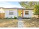 Charming bungalow with a yellow door, landscaping, and a walkway at 3034 Burlington N Ave, St Petersburg, FL 33713