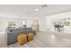 Bright living room with hardwood floors, gray sectional sofa, and adjacent dining area at 3034 Burlington N Ave, St Petersburg, FL 33713