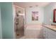 Clean bathroom featuring a shower, tub and updated vanity at 310 Shirley Dr, Largo, FL 33770