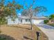 Light blue house with a white garage door at 310 Shirley Dr, Largo, FL 33770