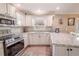 Updated kitchen featuring white cabinets and granite countertops at 310 Shirley Dr, Largo, FL 33770