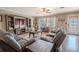 Bright living room featuring hardwood floors, two sofas, and a large TV at 310 Shirley Dr, Largo, FL 33770