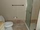 Bathroom featuring tile flooring, a toilet, and a tiled glass-enclosed shower at 3300 Cove Cay Dr # 6G, Clearwater, FL 33760