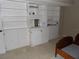 Bedroom closet and cabinets with white built-in shelves and storage at 3300 Cove Cay Dr # 6G, Clearwater, FL 33760