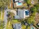 Overhead shot of home showcasing landscaped yard, circular driveway, and fenced in-ground swimming pool at 3310 Carib Rd, Tampa, FL 33618