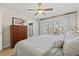 Comfortable bedroom featuring hardwood floors, a ceiling fan, and natural light at 3310 Carib Rd, Tampa, FL 33618