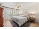 Bright bedroom with light wood floors, ceiling fan, and large windows at 3310 Carib Rd, Tampa, FL 33618