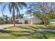 Beautiful single-story home featuring lush landscaping, manicured lawn, and a welcoming front entrance at 3310 Carib Rd, Tampa, FL 33618