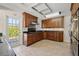 This kitchen features wooden cabinets, mosaic backsplash, stainless appliances and a door to outside at 3310 Carib Rd, Tampa, FL 33618