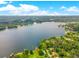 Picturesque aerial view of a lake lined with trees and houses; the Orlando skyline is visible in the distance at 3310 Carib Rd, Tampa, FL 33618