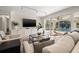 Bright living room with tile flooring, neutral decor, and sliding glass doors to the pool area at 3310 Carib Rd, Tampa, FL 33618