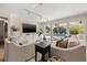 Comfortable living room featuring built-in cabinets and sliding glass doors to the pool area at 3310 Carib Rd, Tampa, FL 33618