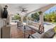 Inviting outdoor living space with tile floors, ceiling fans, tv, and comfortable seating overlooking the refreshing pool at 3310 Carib Rd, Tampa, FL 33618