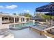 Sparkling pool with lounge chairs under umbrellas, and covered porch with comfortable seating at 3310 Carib Rd, Tampa, FL 33618