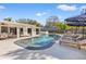 A great view of the outdoor pool, lounge chairs and umbrellas with partial view of covered porch at 3310 Carib Rd, Tampa, FL 33618