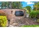 Original Carrollwood entrance sign with brick facade, lush greenery and exterior lighting at 3310 Carib Rd, Tampa, FL 33618