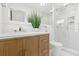 Bathroom with a wood vanity, white counter, glass shower, and brushed nickel faucet at 3499 43Rd N St, St Petersburg, FL 33713