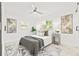 Well-lit bedroom featuring a ceiling fan, neutral decor, and light wood floors at 3499 43Rd N St, St Petersburg, FL 33713