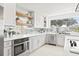 Bright kitchen with white cabinets, stainless steel appliances, mirrored backsplash, and an open layout at 3499 43Rd N St, St Petersburg, FL 33713